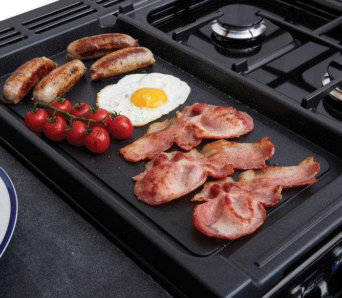 Falcon dual fuel hob with ceramic multi-zone with sausages, bacon and egg